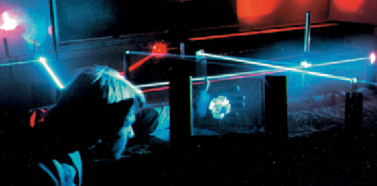 A picture of a student viewing his hologram under laser light.